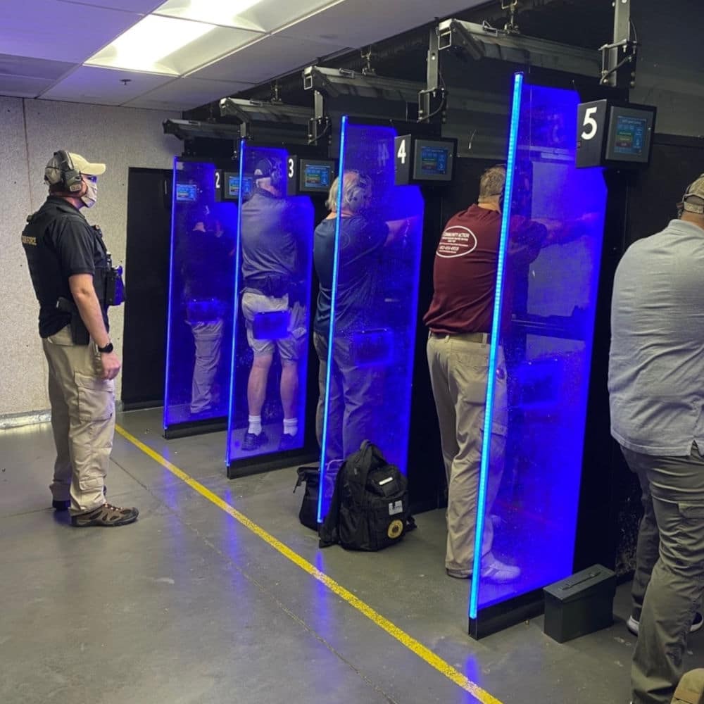 armed guard training at an indoor shooting range