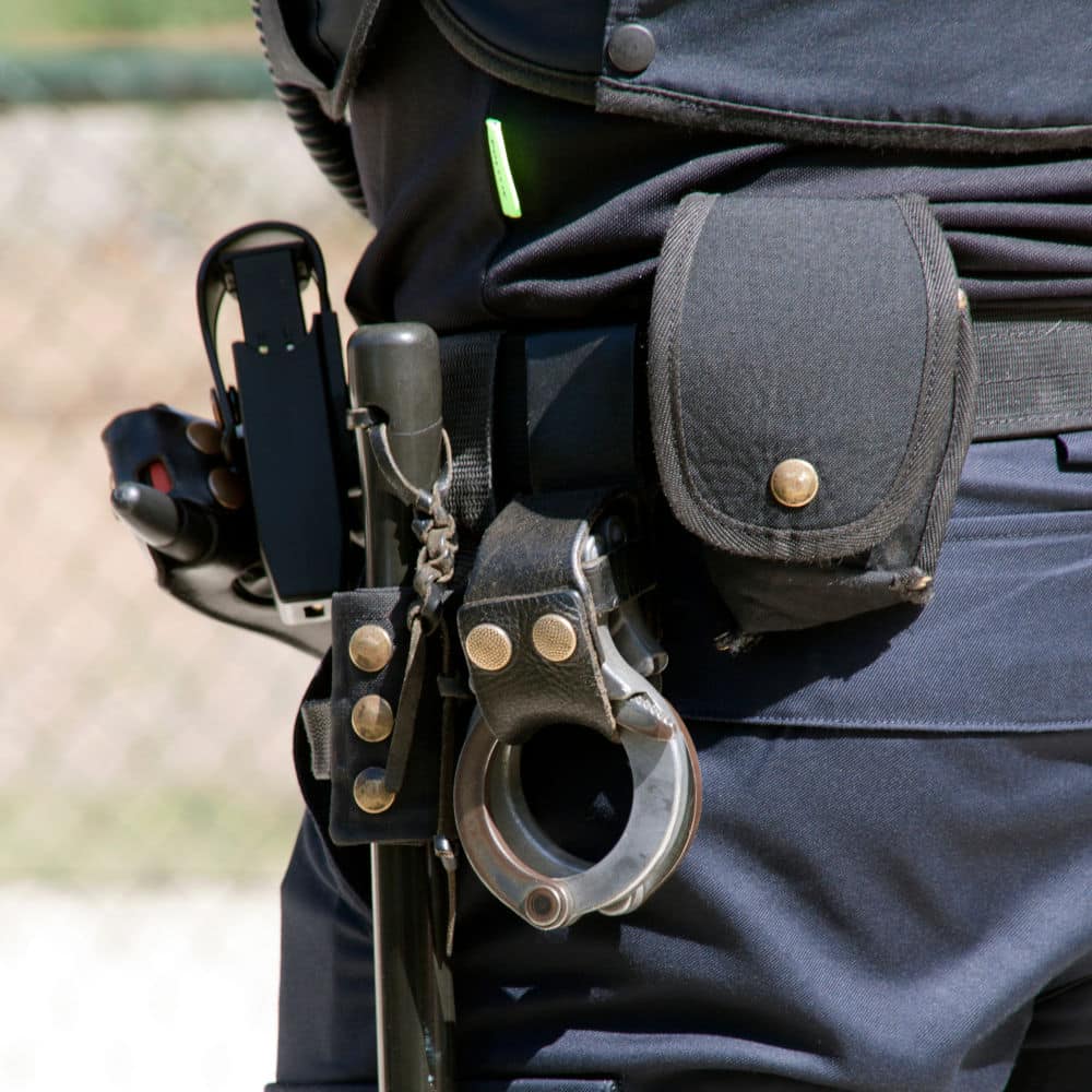 handcuffs and baton on security guard belt